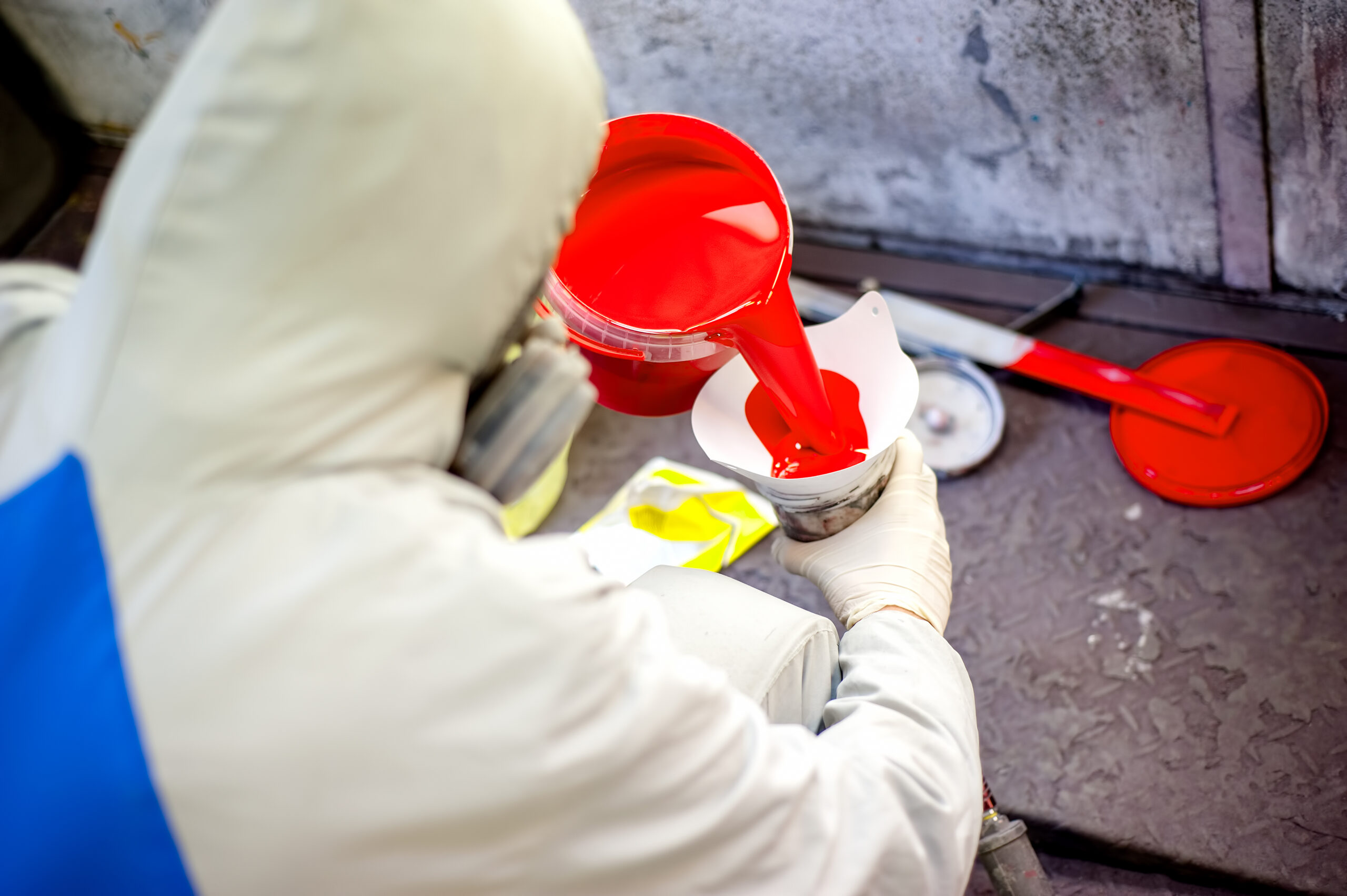 Auto mechanic mixing and pouring red paint for spraying and A man painting a car Paint and Body Shops